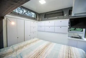 11 large drawers and two full-height cupboards surround the master bed