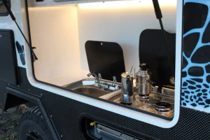 Always-ready kitchen with 3-burner cooktop and plumbed stainless steel sink